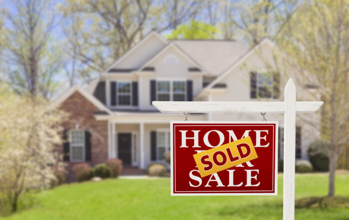 Sold Home For Sale Real Estate Sign and Beautiful New House.