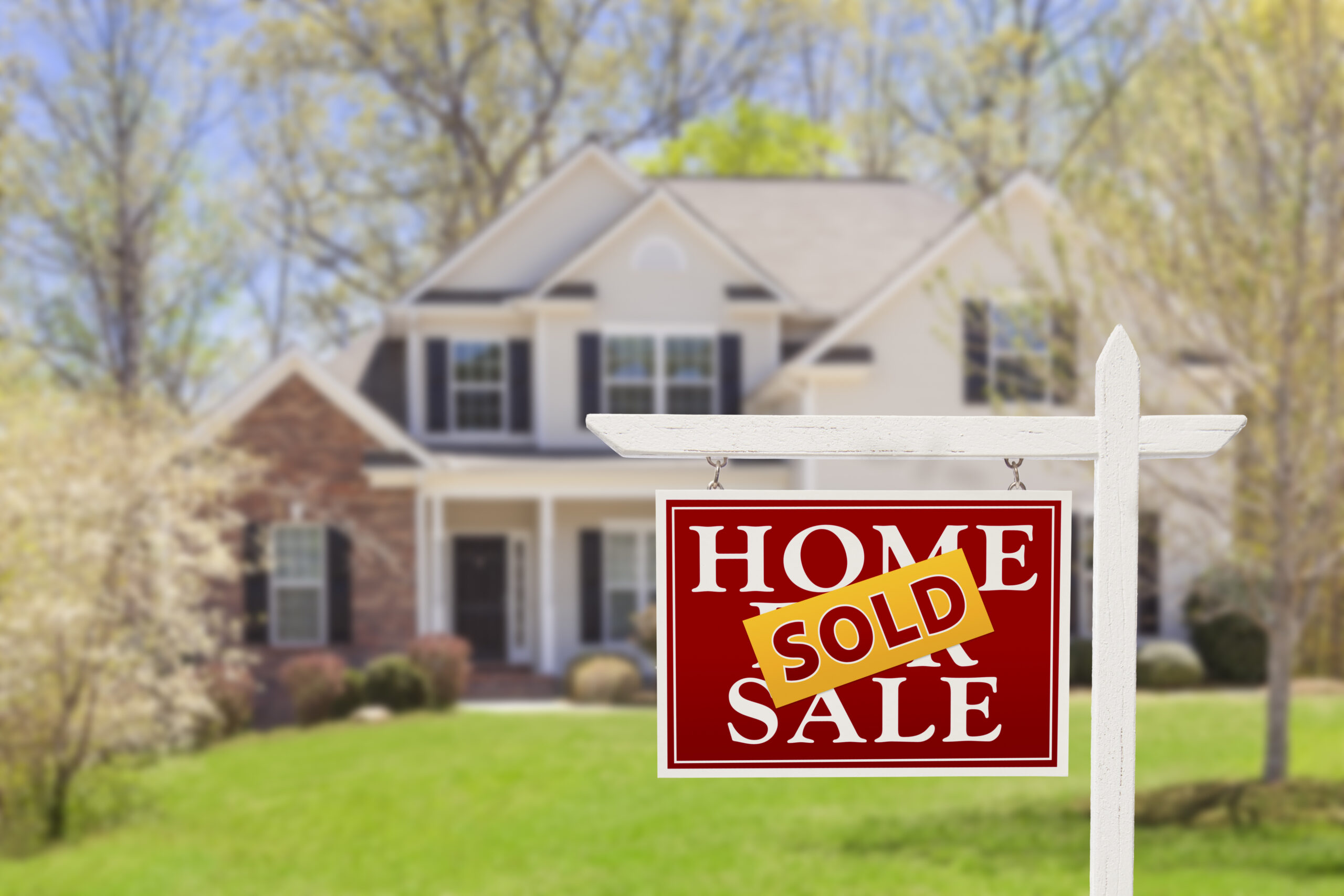 Sold Home For Sale Real Estate Sign and Beautiful New House. Sold Home For Sale Real Estate Sign and Beautiful New House.
